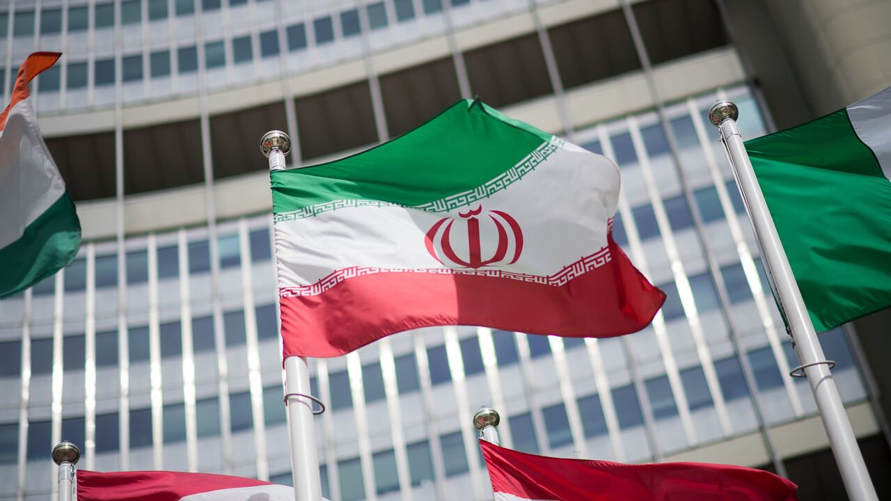 The flag of Iran is seen in front of the building of the International Atomic Energy Agency (IAEA) Headquarters ahead of a press conference by Rafael Grossi, Director General of the IAEA, about the agency's monitoring of Iran's nuclear energy program on May 24, 2021 in Vienna, Austria.  