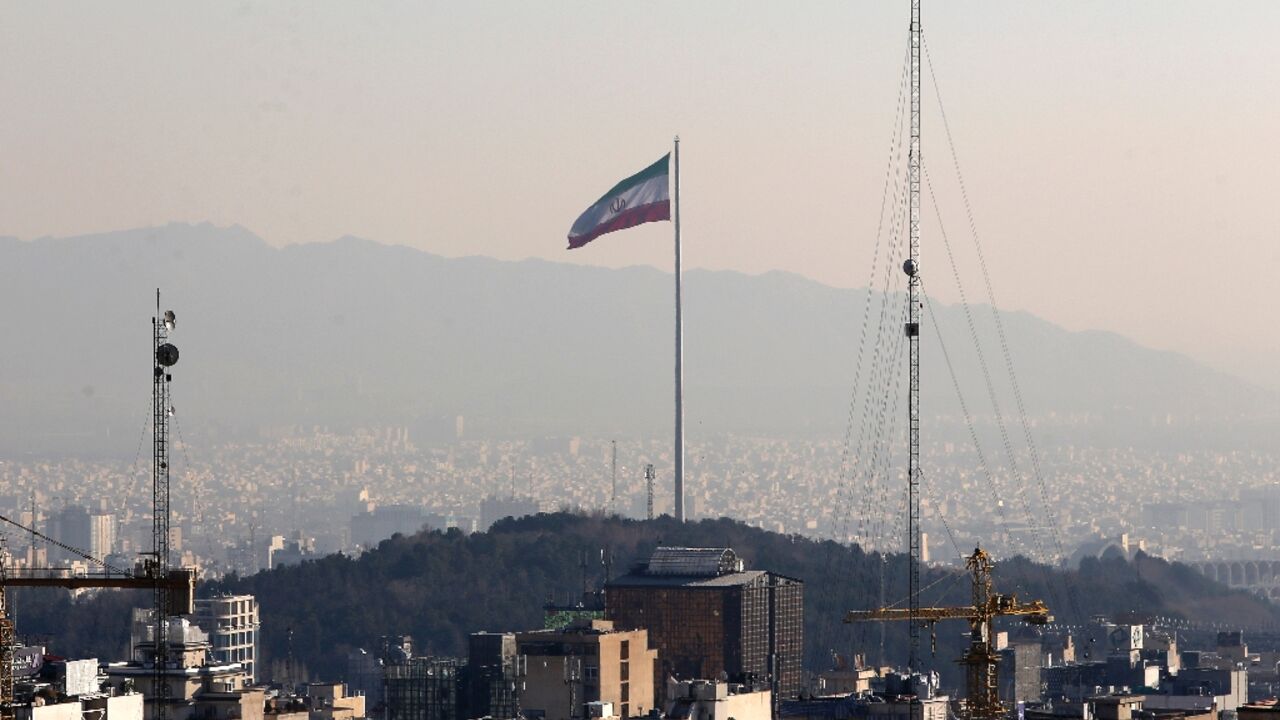 The Iranian capital of Tehran is seen in January 2023, with the country's flag fluttering in the wind