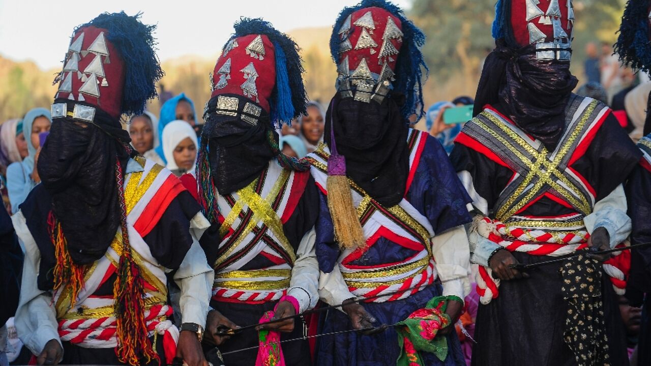 Men perform a traditional dance during the Sebeiba Festival, a yearly celebration of Tuareg culture, in the oasis town of Djanet in southeastern Algeria, on July 29, 2023