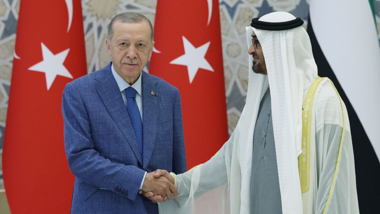 UAE President Mohamed bin Zayed Al Nahyan (R) greeting Turkey's President Recep Tayyip Erdogan