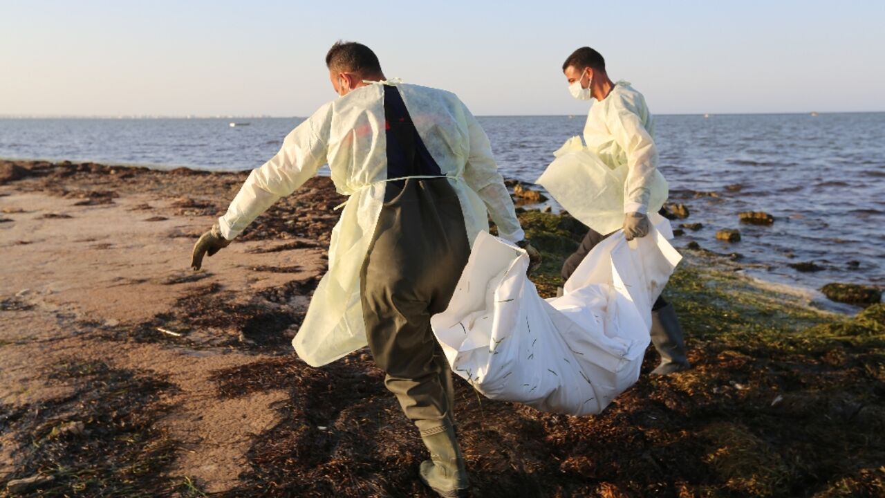 Tunisian civil protection workers recover the body of an African migrant near the eastern city of Zarzis, on July 16, 2019, after a string of deadly shipwrecks 