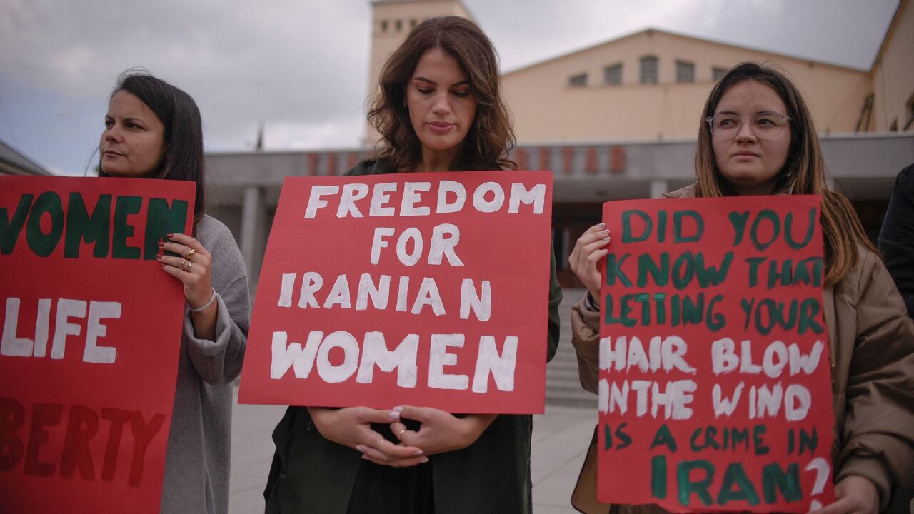 Women take part in a rally in support of Iranian women in Pristina on Oct. 12, 2022.