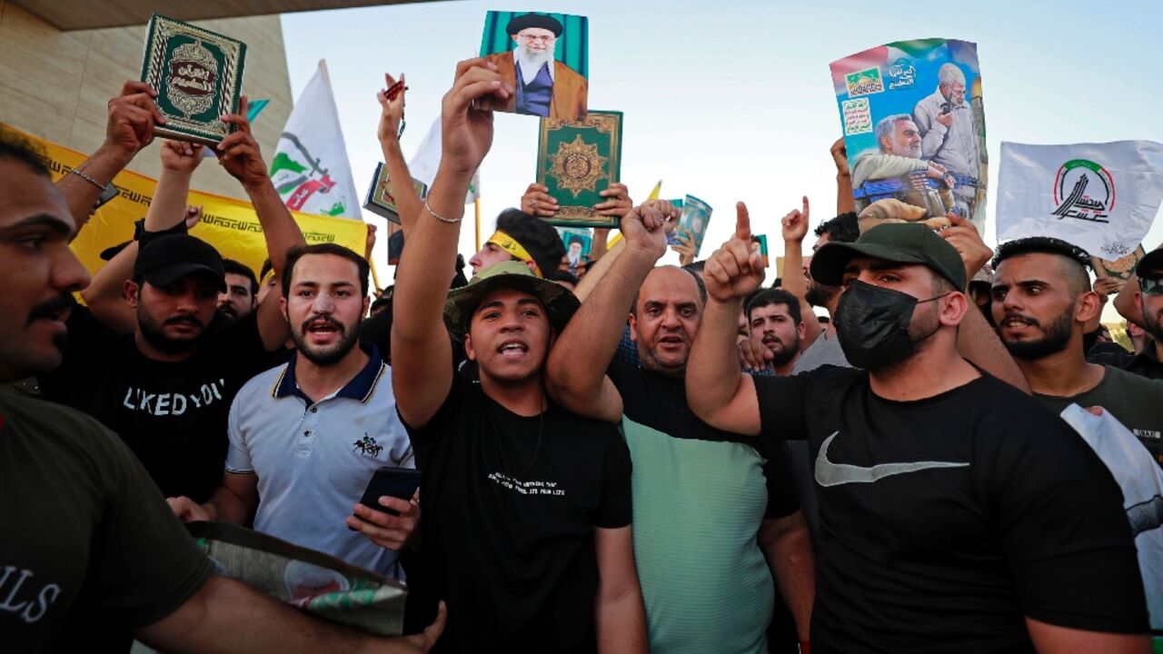 Iraqi protesters in Baghdad carry copies of the Koran to denounce the latest desecration of the holy book in Sweden