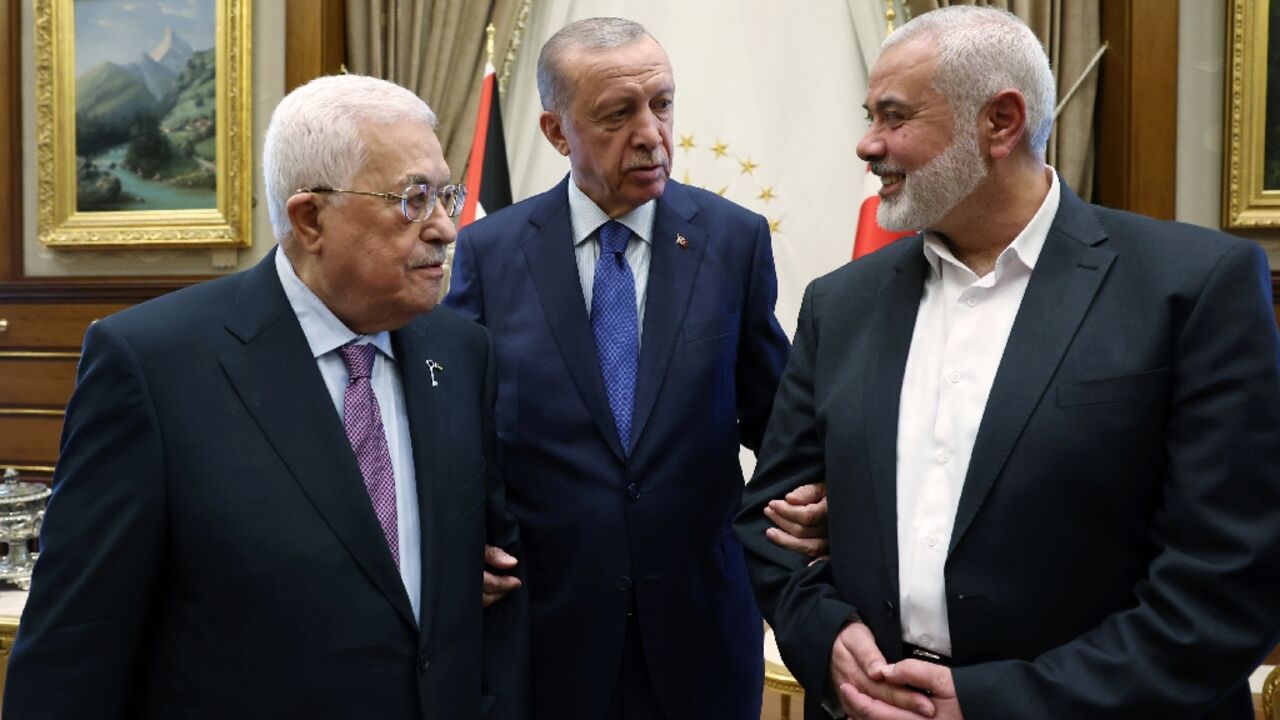 This handout photograph taken and released by the Turkish Presidency Press Office on July 26, 2023, shows Turkish President Recep Tayyip Erdogan (C) meeting with Palestinian President Mahmoud Abbas (L) and the leader of the Palestinian Hamas movement Ismail Haniyeh (R) at the Presidential Complex in Ankara.