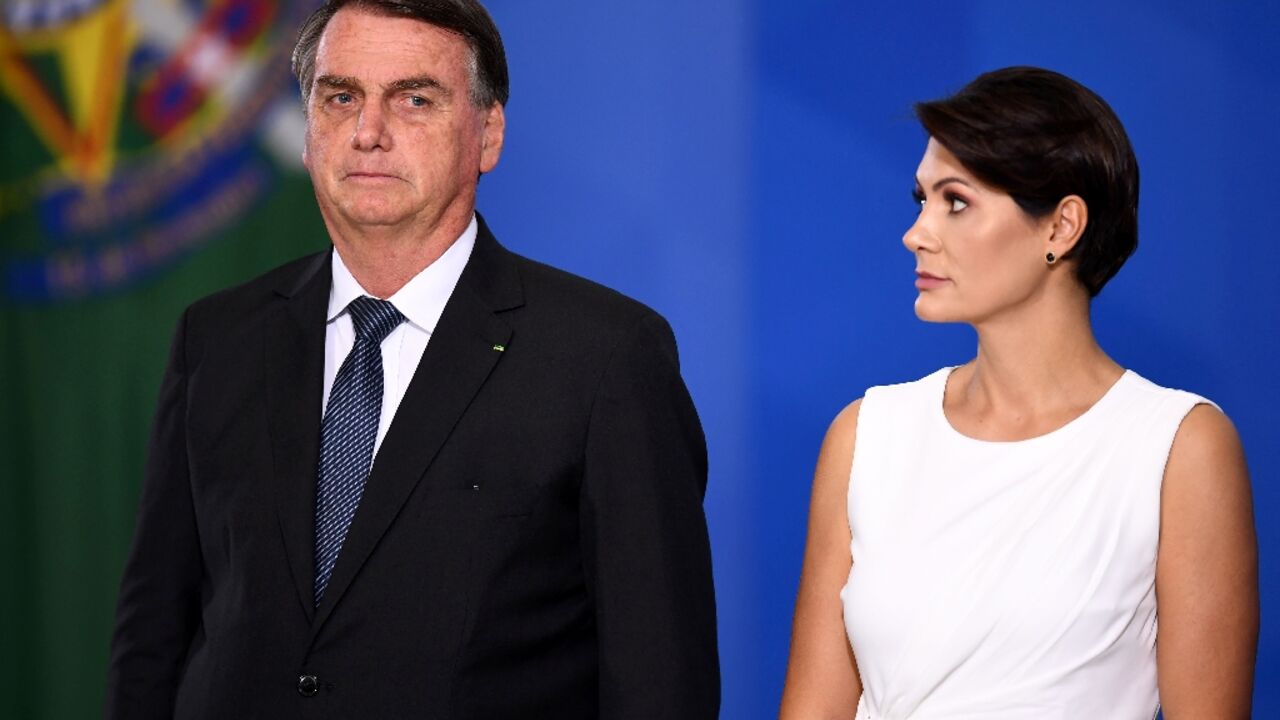 Brazilian President Jair Bolsonaro (L) and his wife Michelle Bolsonaro deny any wrongdoing over allegations of trying to embezzle pricey jewelry and other official gifts from foreign countries