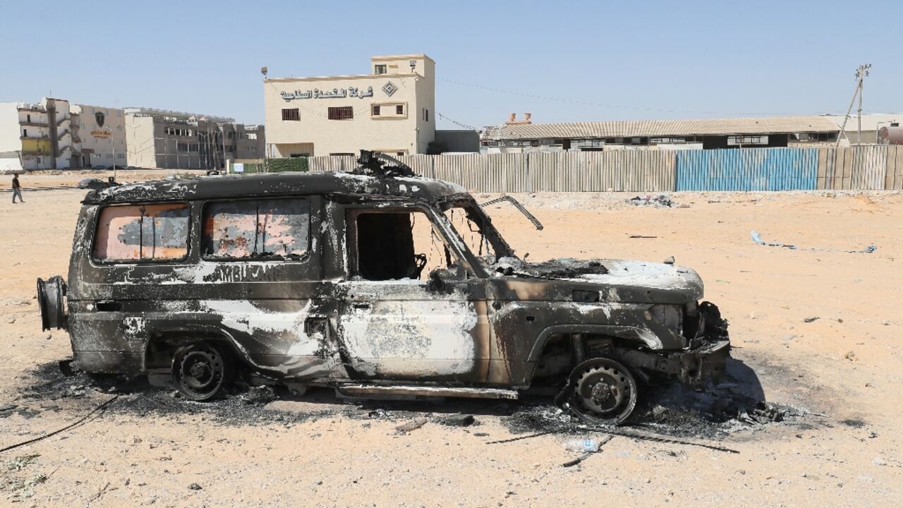 A car gutted by fire is pictured after two days of deadly clashes in Libya's capital