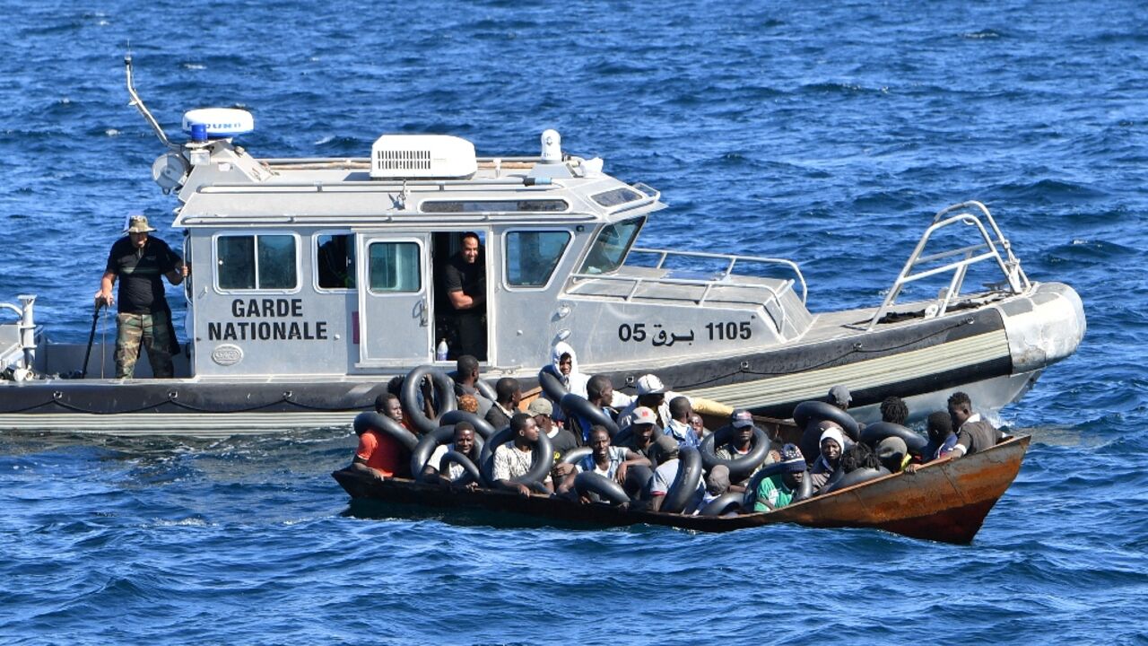 Tunisian coastguard officers intercept a migrants boat at sea, on August 10