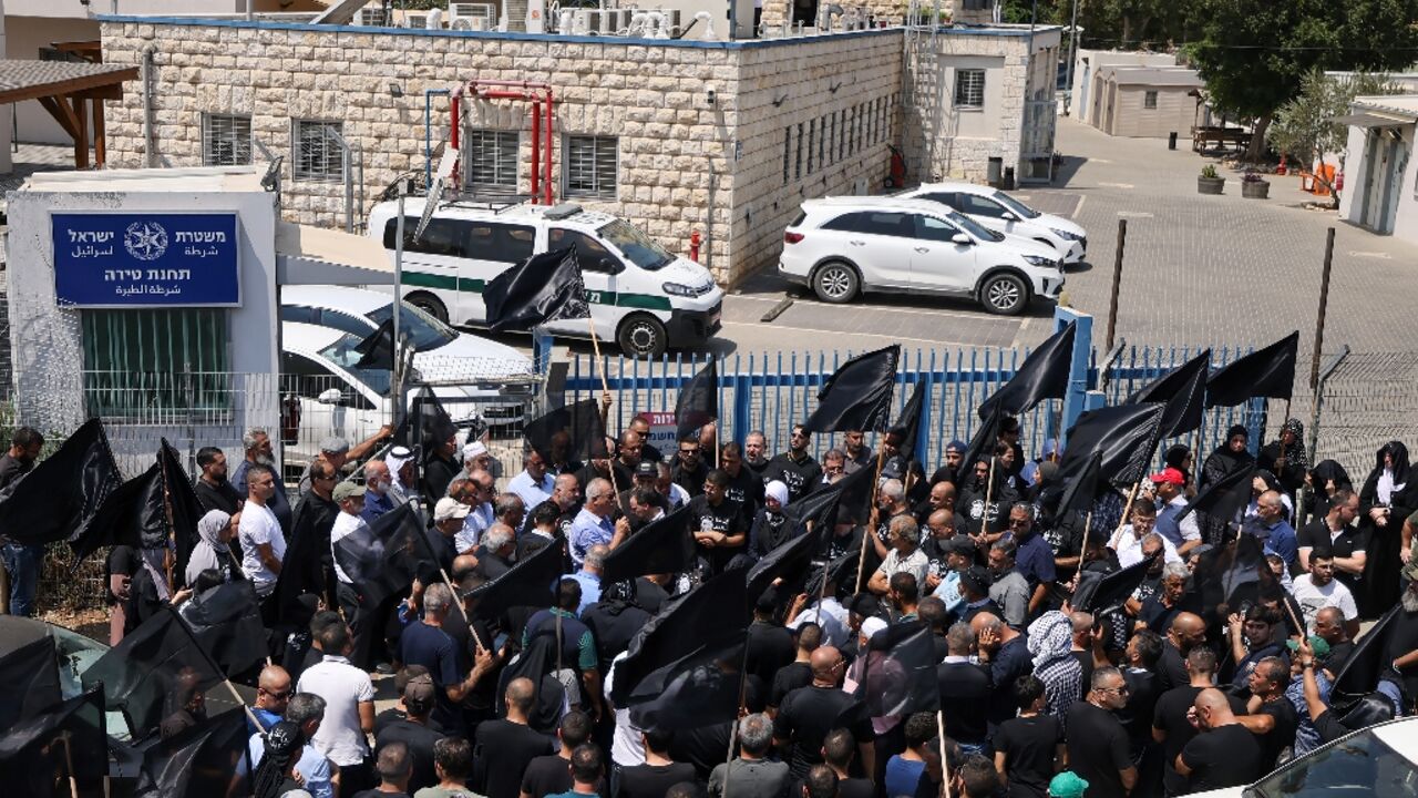 Arab Israelis protest outside a police station during the funeral for the director-general of Tira city, the latest victim of a crime wave in the Arab-Israeli community