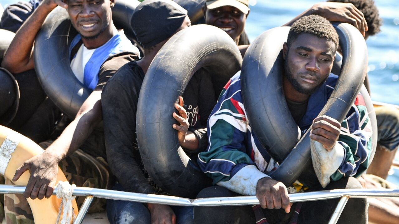 Migrants of African origin are seen crammed aboard a small boat after being intercepted by Tunisia's coastguard