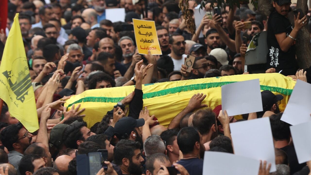 People carry the body of a fighter of the Lebanese Hezbollah movement during his funeral after he was killed in clashes