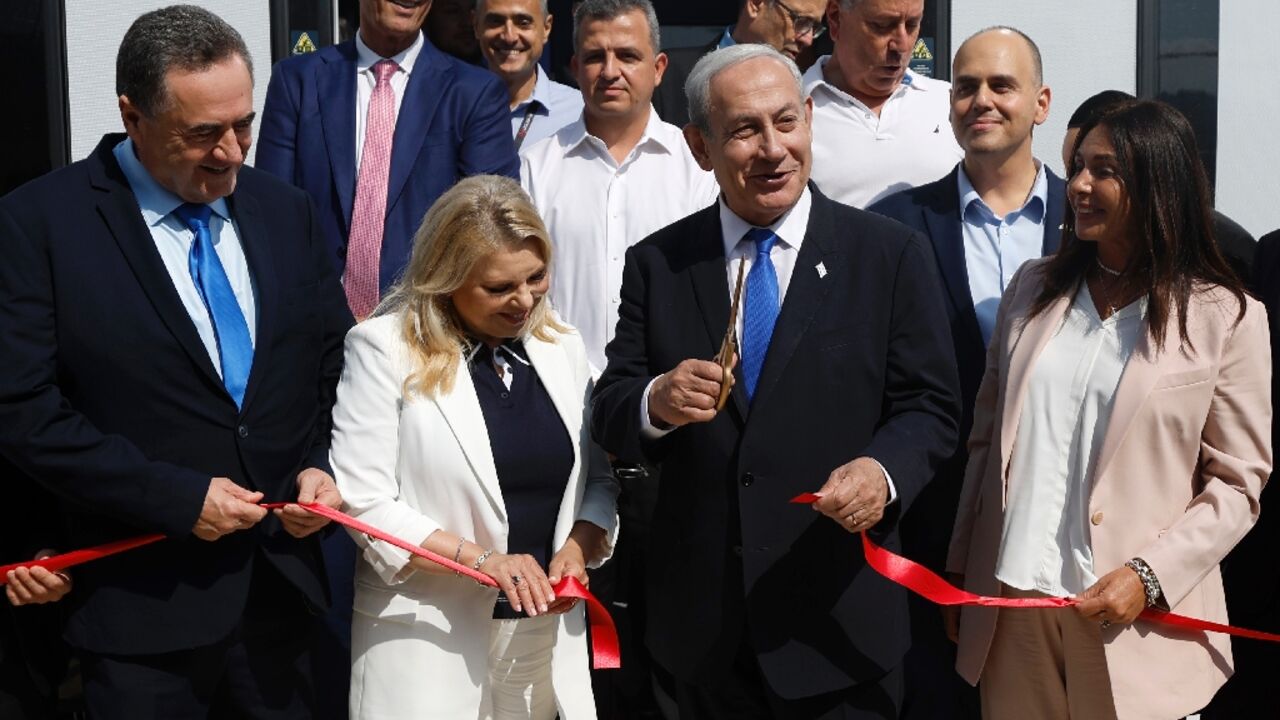 Netanyahu opens the light rail line, accompanied by his wife Sara (L) and Transport Minister Miri Regev