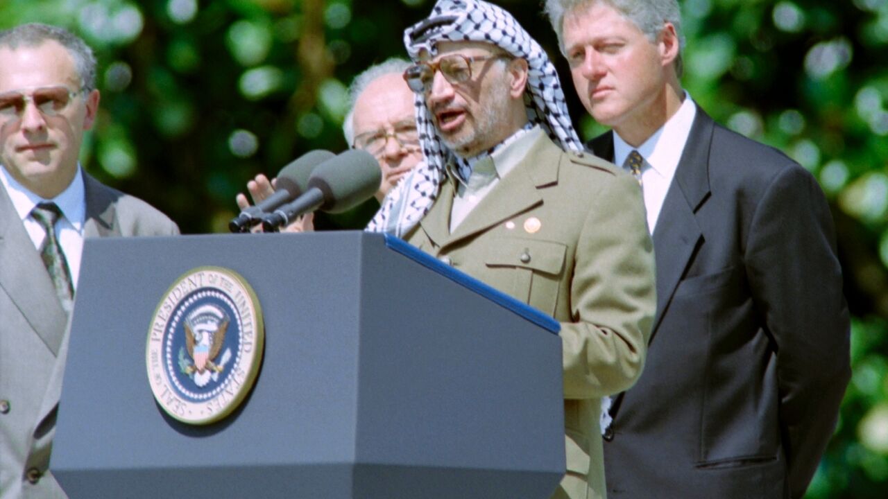 PLO chairman Yasser Arafat joins Israeli premier Yitzhak Rabin and US president Bill Clinton for the signing of the first Oslo Accord on September 13, 1993
