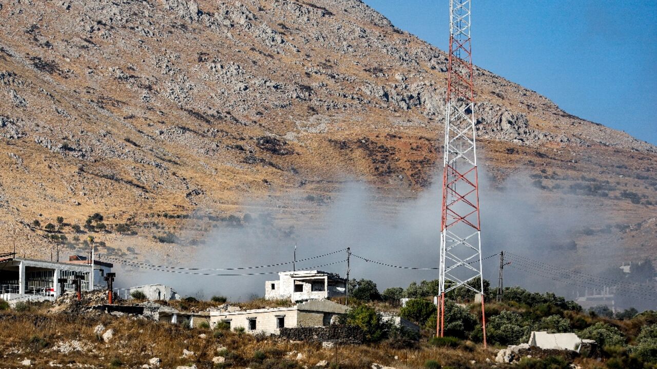 Smoke rises from a Syrian army position after an Israeli tank fires across the demarcation line from the occupied Golan Heights