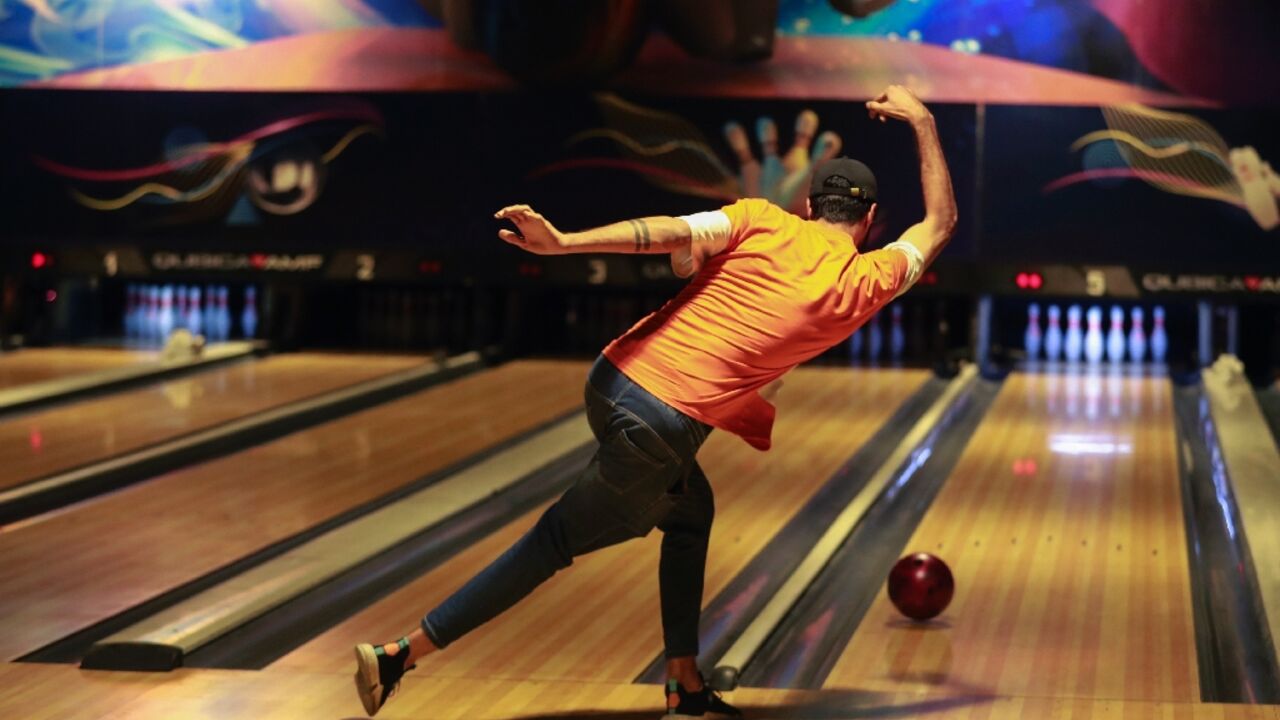 An Iraqi delivers a ball at a bowling alley in Baghdad