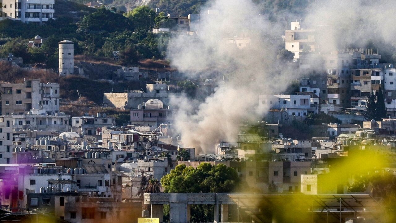 Smoke billows after a projectile hits near a centre of the Palestinian Fatah movement in the Ain al-Helweh camp for Palestinian refugees in Lebanon's southern coastal city of Sidon on September 10, 2023