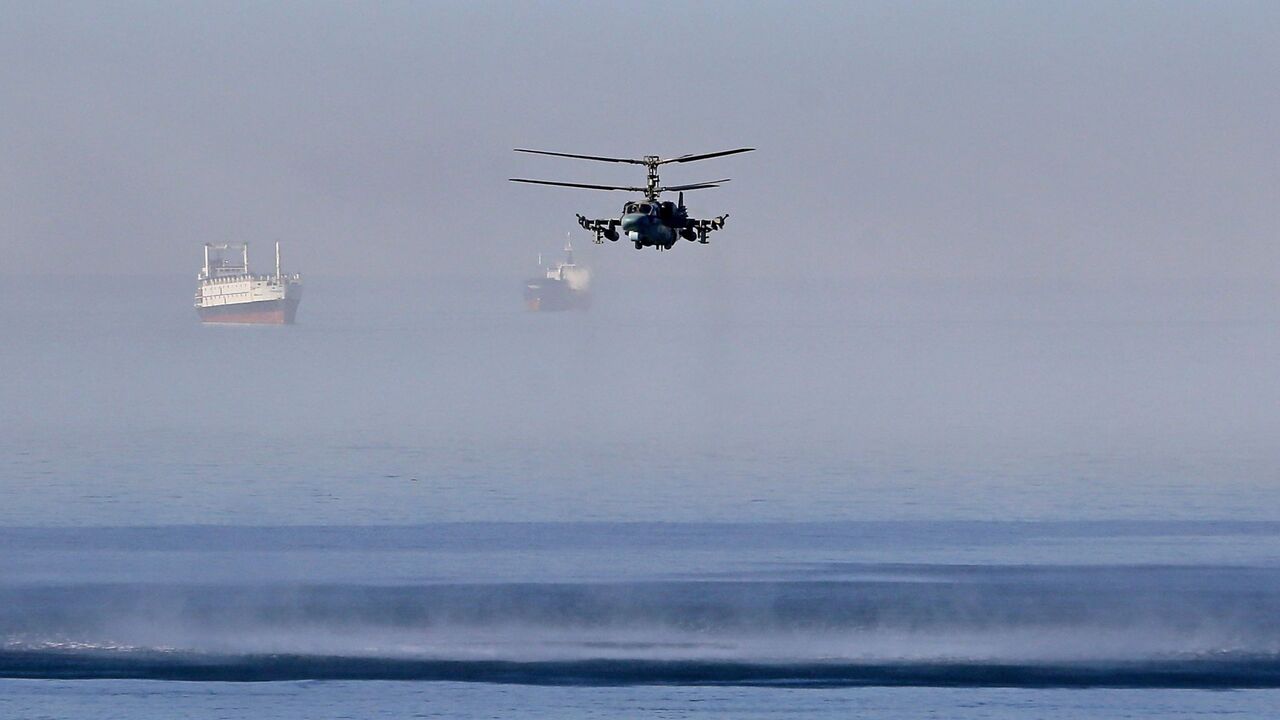 A Russian helicopter flies off the coast of the Syrian port city of Tartus, July 25, 2022.