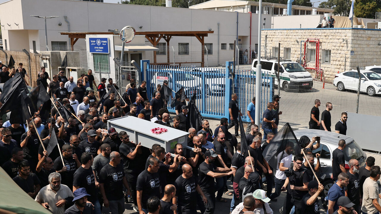 Arab Israeli mourners carry the casket of Abdelrahman Kashua