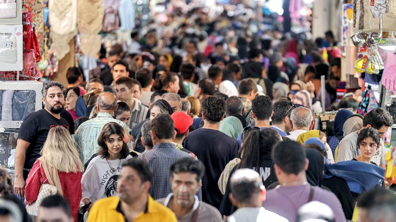 People walk at the Grand Bazaar in Tehran on September 5, 2023