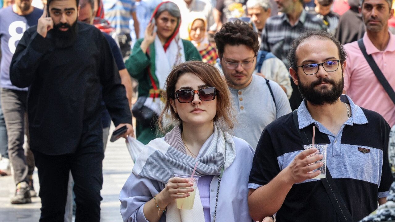 People walk outside Tehran's Grand Bazaar, nearly a year after Mahsa Amini's death that triggered nationwide protests