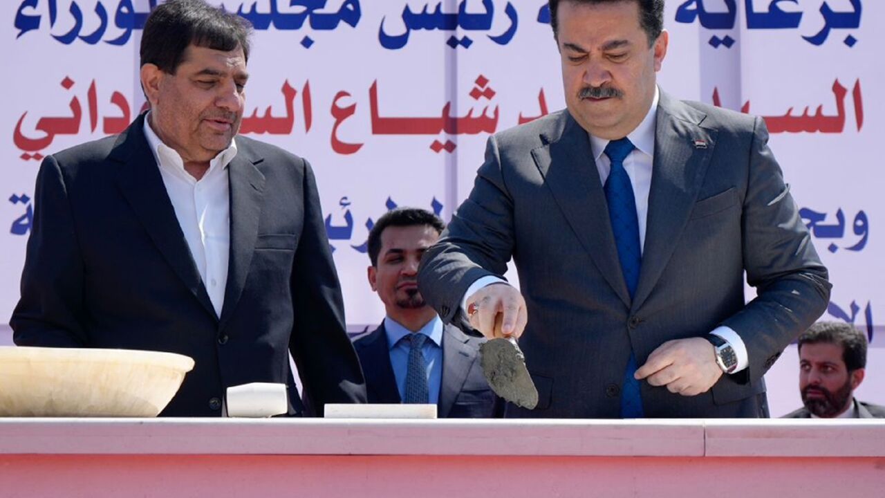 Prime Minister Mohammed Shia al-Sudani (R) and Iran's Vice President Mohammad Mokhber lay the foundation stone