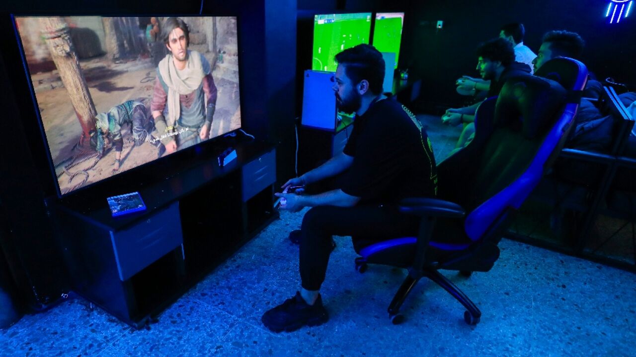A man plays the newly released video game 'Assassin's Creed Mirage' in a cybercafe in Baghdad on October 4, 2023