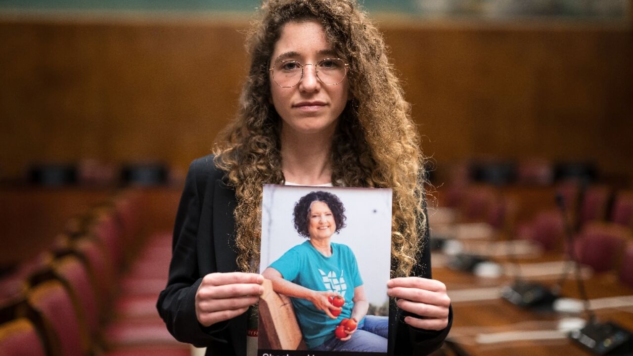 Israeli-German Noam Har Tzvi holds a picture of her missing friend Shoshan Haran 