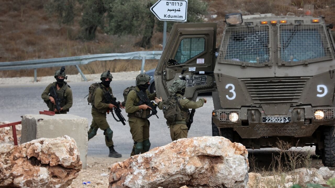 Israeli soldiers patrol near the West Bank city of Tulkarm where two Palestinians were reportedly killed during clashes with Israeli forces 