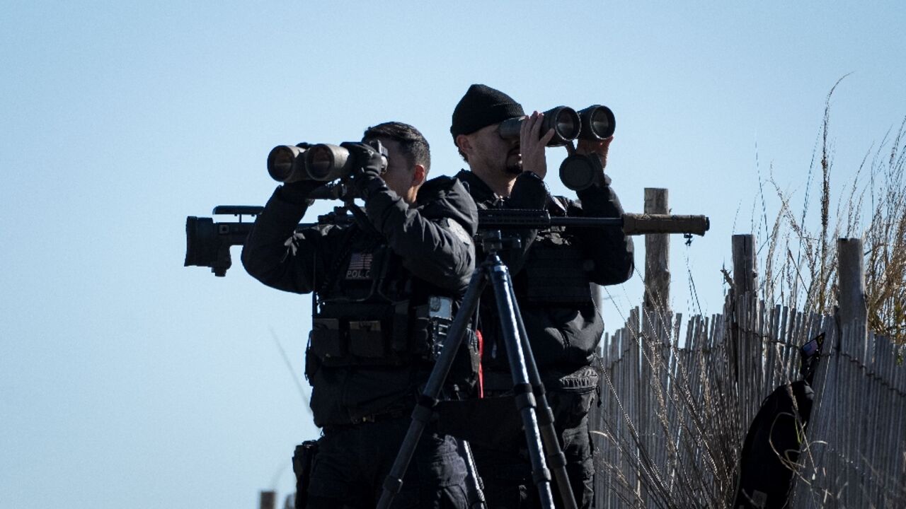 United States Secret Service counter-snipers and other security personnel keep watch as US President Joe Biden and First Lady Jill Biden board Marine One in Rehoboth Beach, Delaware