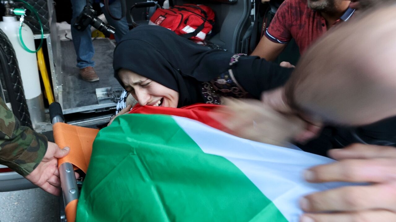 A woman cries over the body of Moath Odeh, 29, one of four Palestinians killed when armed Israeli settlers attacked a town in the occupied West Bank