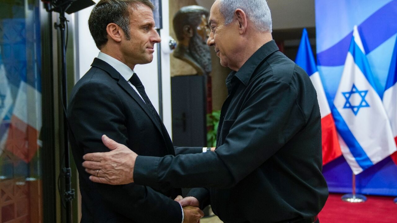 French President Emmanuel Macron (L) meets Israeli Prime Minister Benjamin Netanyahu in Jerusalem ahead of talks in Ramallah with Palestinian leader Mahmud Abbas