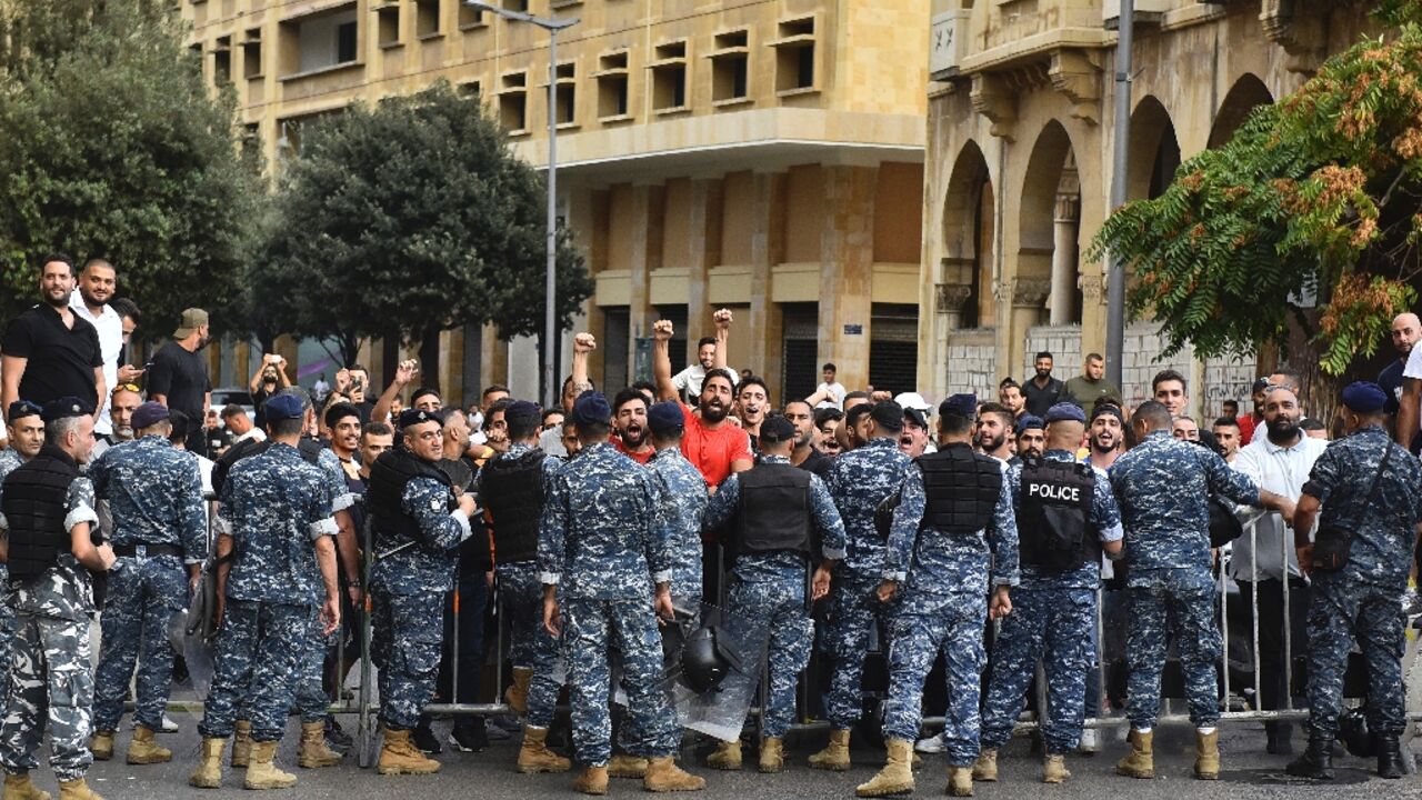 Police stop men from intercepting a march in support of liberties in Beirut