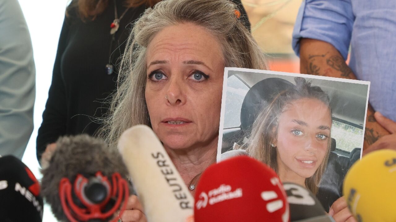 French-Israeli woman Keren Shem, holds a picture of her daughter Mia, held hostage by Hamas militants in Gaza, at a news conference in Tel Aviv called to press for her release
