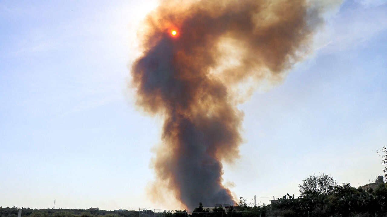 A smoke plume covers the sun during a forest fire that reportedly ignited after shell fire from Israel, in the Labouneh area in southern Lebanon close to the border with northern Israel, on October 26, 2023, amid the ongoing battles between Israel and the Palestinian group Hamas in the Gaza Strip. (Photo by AFP) (Photo by -/AFP via Getty Images)
