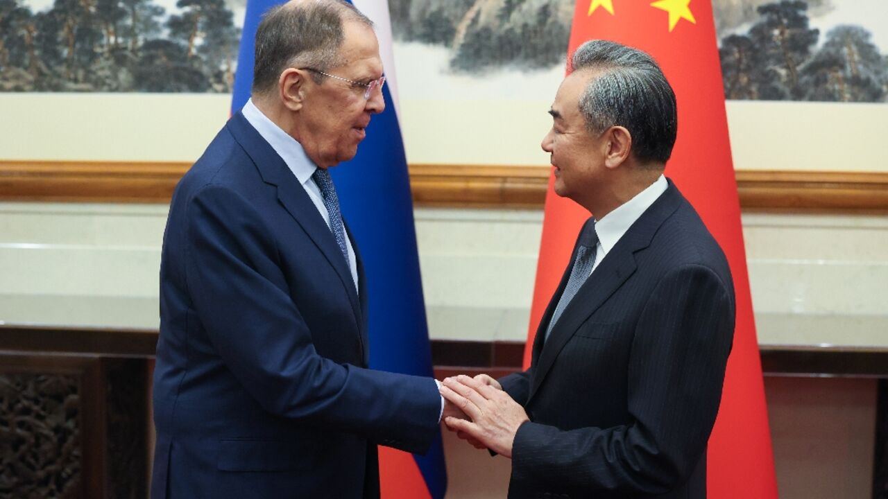 This handout picture taken and released by the Russian Foreign Ministry on October 16, 2023 shows Russian Foreign Minister Sergei Lavrov meeting his Chinese counterpart Wang Yi in Beijing. 