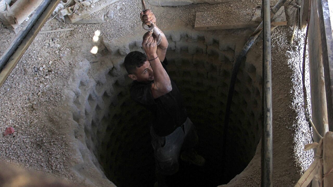 A Palestinian worker is lowered into a tunnel dug beneath the Gaza-Egypt border, in 2013