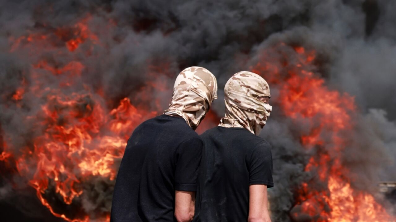 Palestinians burned tyres in clashes with Israeli security forces during Dmidi's funeral