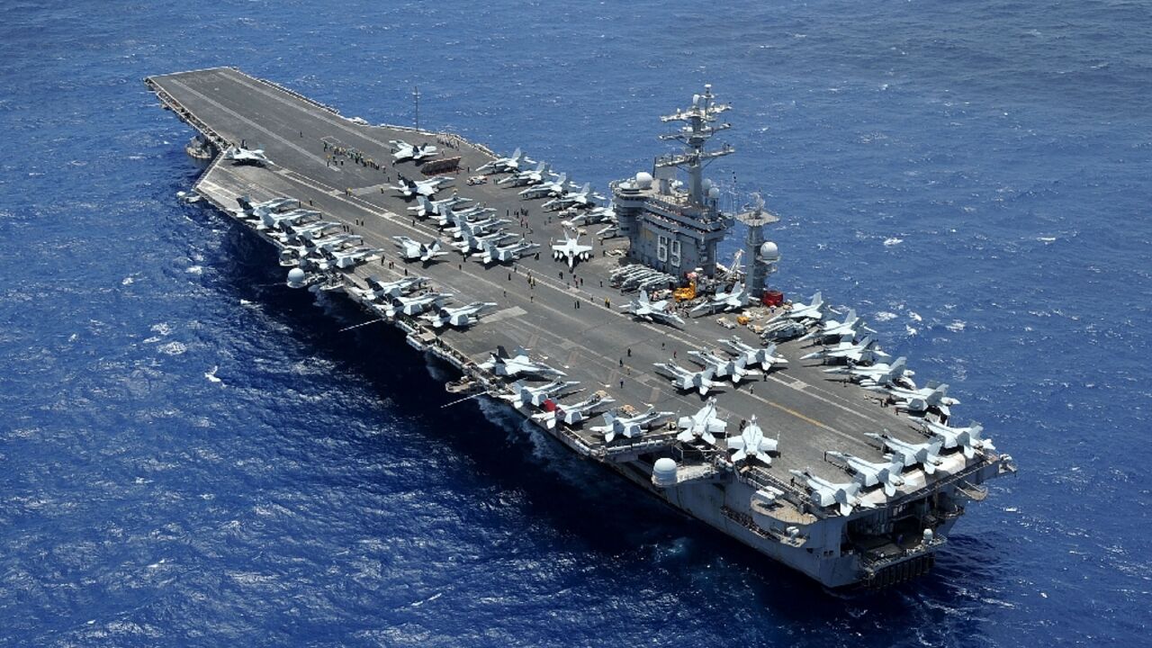 In this image released by the US Department of Defense, the aircraft carrier USS Dwight D. Eisenhower returns to homeport at Norfolk, Virginia on July 2, 2013