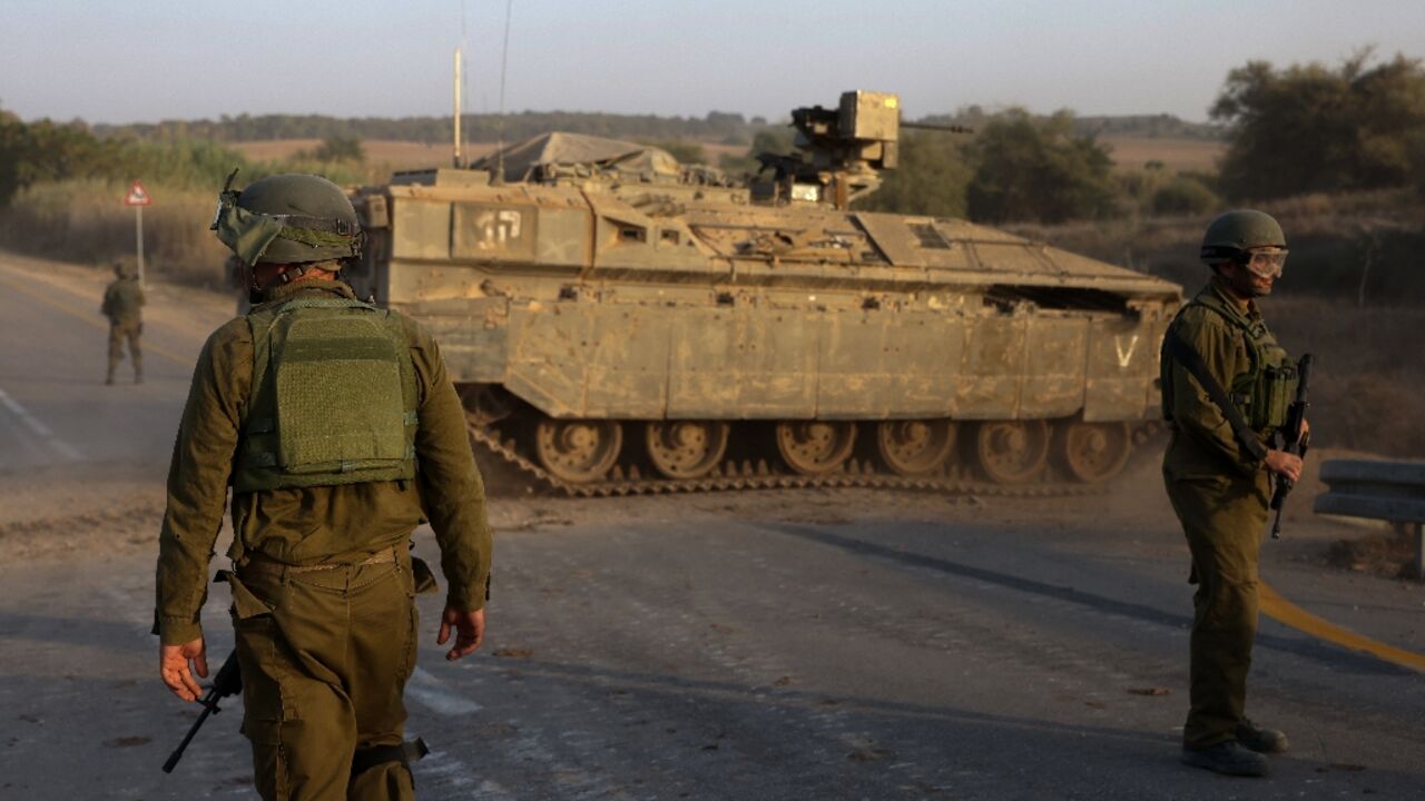 Israeli soldiers and an armoured personnel carrier near Sderot on the border with the Gaza Strip