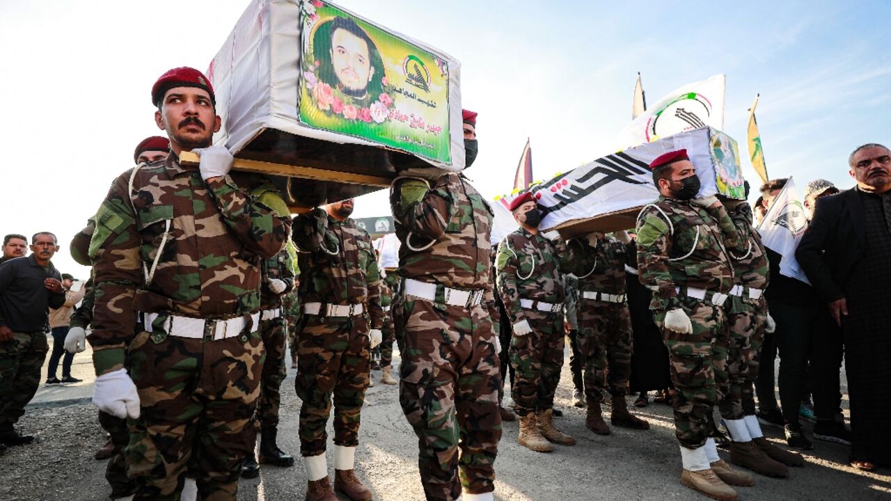 Hashed al-Shaabi soldiers carry the coffins of fighters killed in the US strikes