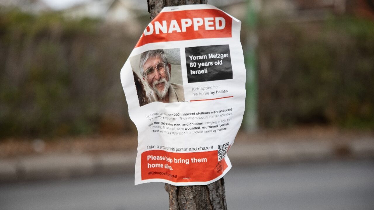 A poster showing the photo of 80 year old Israeli hostage Yoram Metzger is displayed on a tree in Hampstead, Quebec, Canada