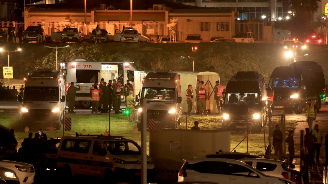 Ambulances wait by the helipad of Tel Aviv's Schneider medical centre for the arrival of some of the first batch of 13 Israeli hostages released by Hamas in Gaza