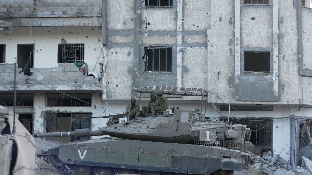 Israeli troops are pictured during operations in northern Gaza on November 8 during a controlled tour