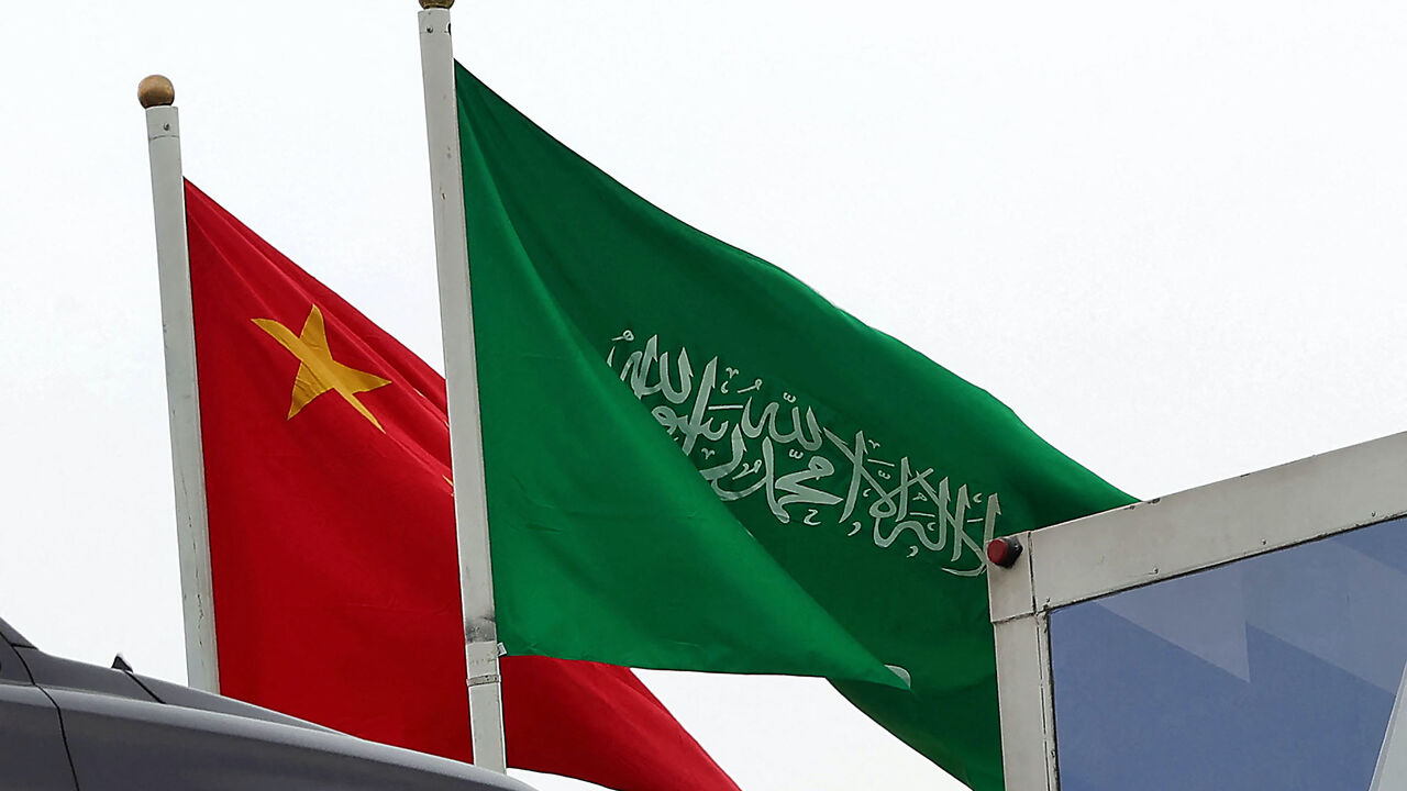 A picture taken on December 7, 2022 in Riyadh, shows the Chinese and the Saudi flags adorning a street ahead of the Chinese president's visit to the Saudi capital. 