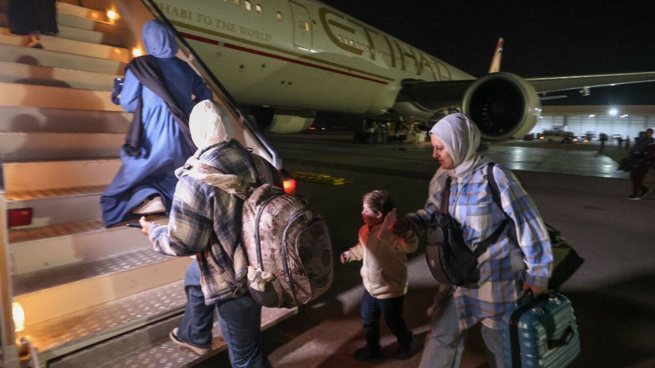 Palestinians evacuated from the Gaza Strip board a plane at Egypt's El-Arish International Airport bound for Abu Dhabi