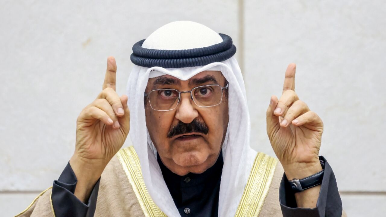 Kuwait's new emir Sheikh Meshal al-Ahmad al-Sabah gestures as he swears in before lawmakers as the country's 17th ruler