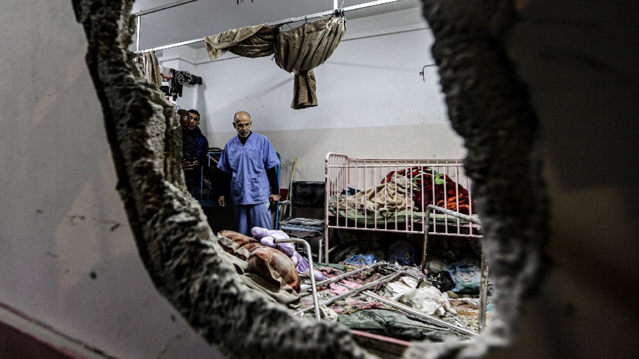 People inspect bombing damage at Nasser hospital in Khan Yunis in the southern Gaza Strip on December 17, 2023