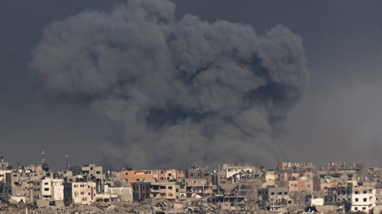 A picture taken from southern Israel near the border with the Gaza Strip on December 12, 2023 shows smoke billowing during Israeli bombardment of the Palestinian territory 