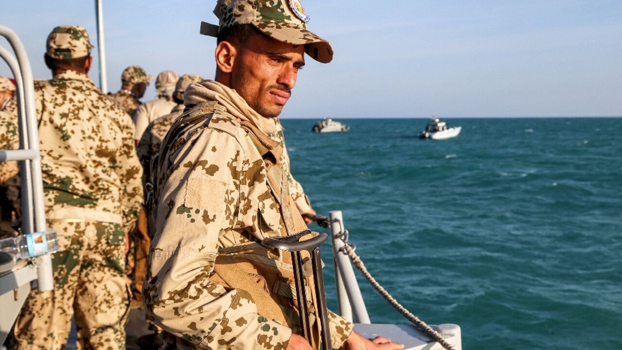 A Yemeni coastguard member loyal to the internationally recognised government in a patrol boat in the Red Sea off of the government-held town of Mokha, close to the strategic Bab al-Mandab Strait, on December 12, 2023