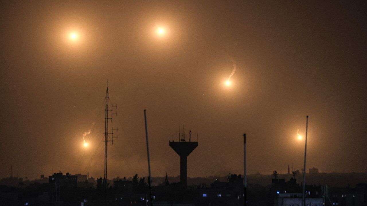 A picture taken from Rafah shows flares fired by Israeli soldiers over Khan Yunis in the southern Gaza Strip 