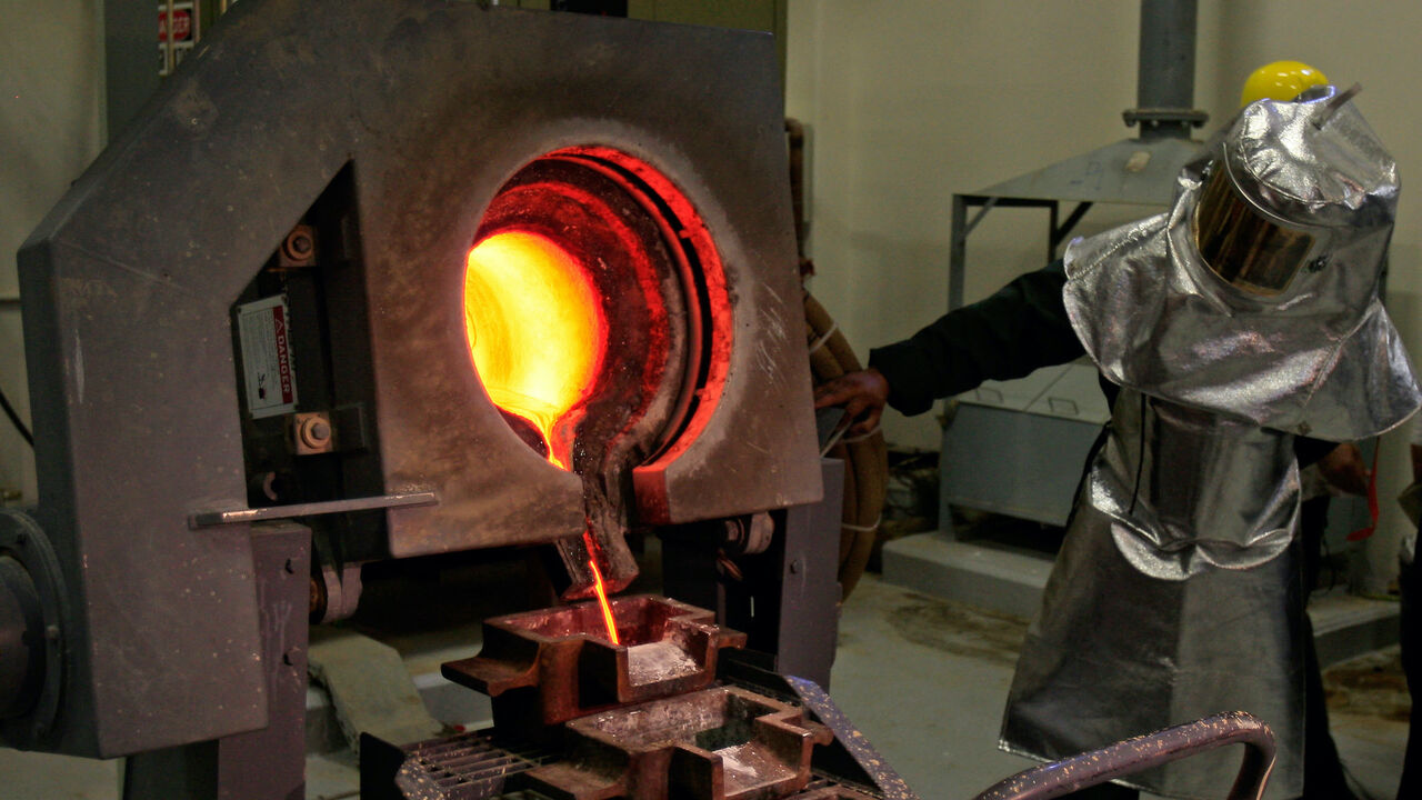 A Saudi mine worker pours a stream of molten gold from the furnace into moulds to produce gold ingots during a press tour at the Al-Amar Gold Mine, 195kms southwest of the Saudi capital Riyadh, on May 28, 2008. Al-Amar is an underground mine which is designed to process ore at a rate of 200ktpa to produce gold which is then sold to third parties for toll smelting. Construction was completed during the half year period ended 30 June 2007 and the facility is currently undergoing commissioning and production b